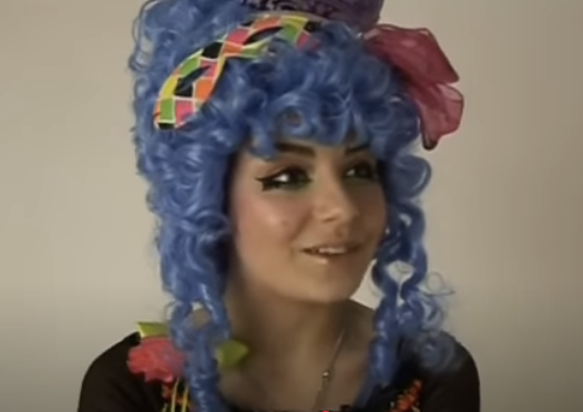 A teenage Charli XCX with a blue wig and costume makeup from a 2010 interview